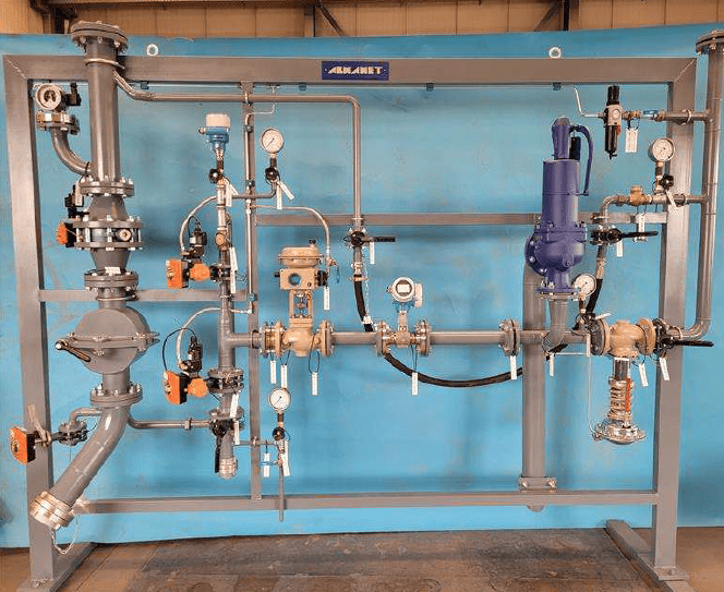 Industrial unloading stations with piping and valves for fluid transfer.
