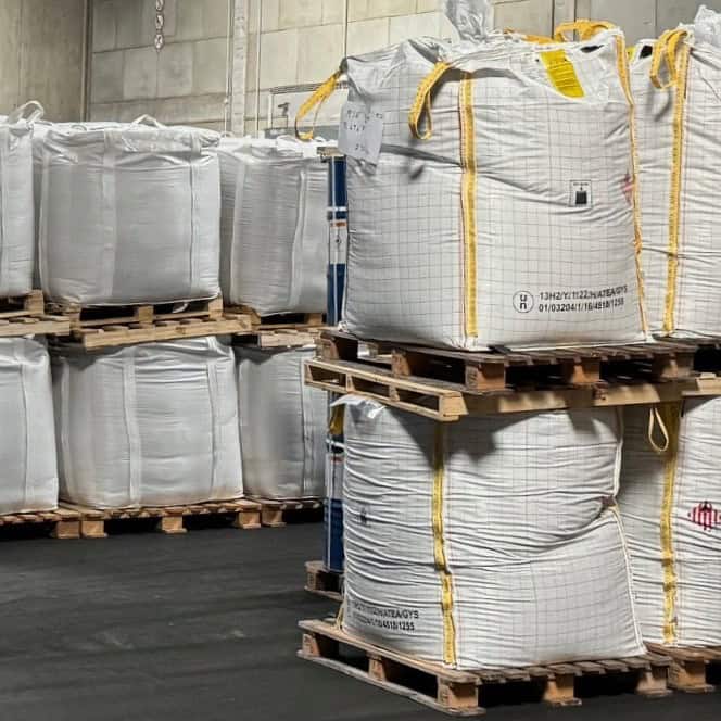 Magnesium raspings stored in large industrial bags on pallets.