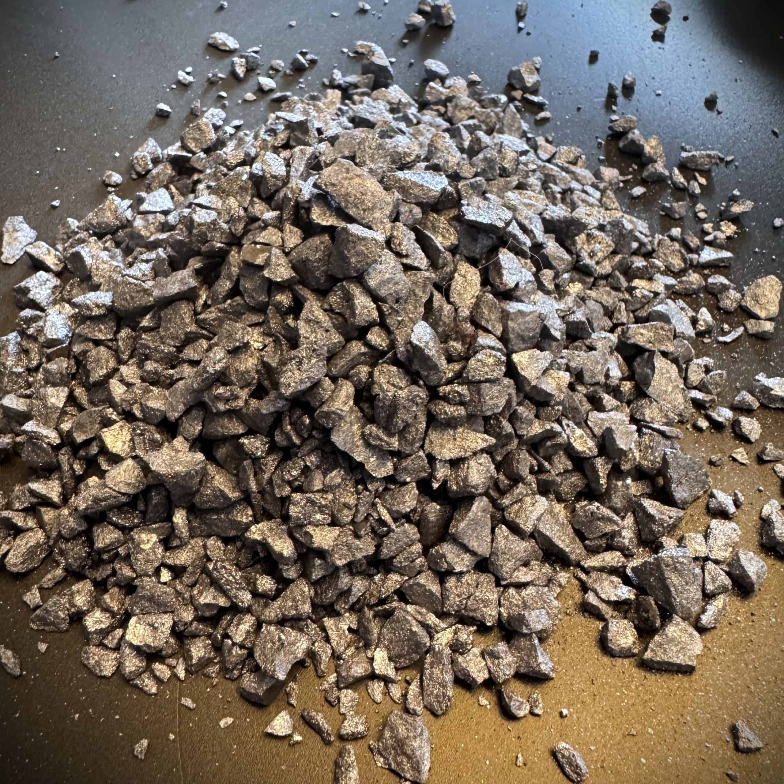 Ferro alloys raw material for steel production, metallic mineral chunks.